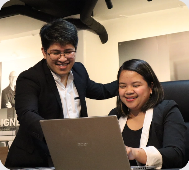 Mustard Seed colleagues helping each other at a laptop